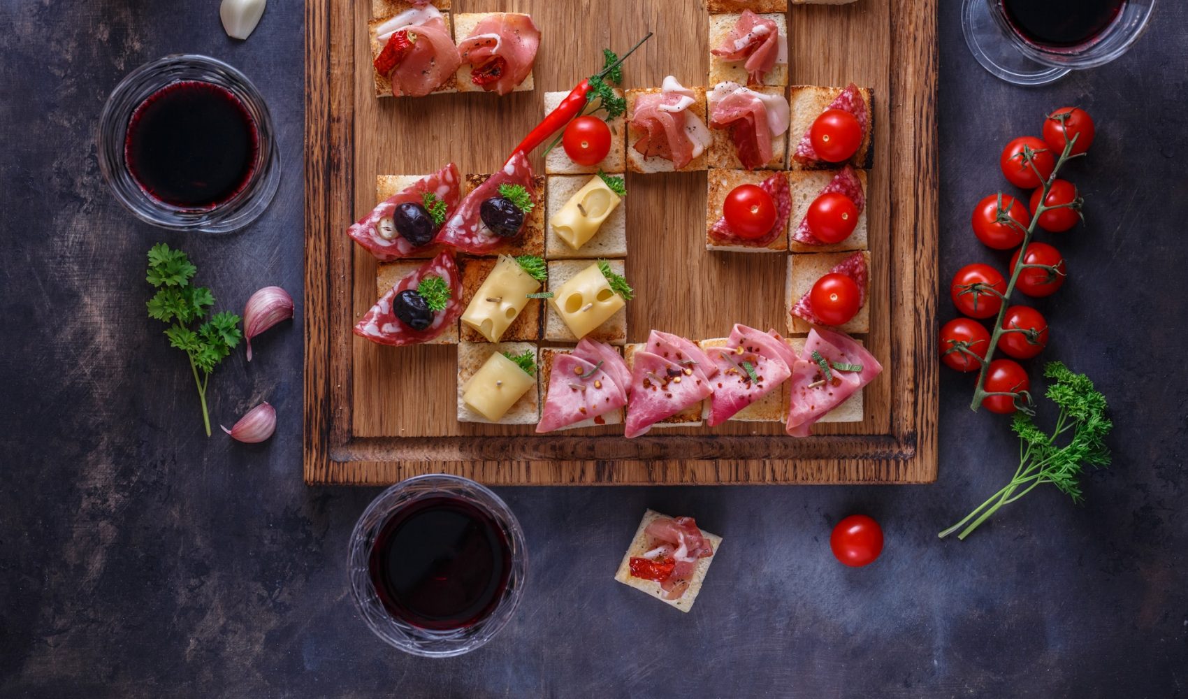 close view of small tapas topped with jamon cured meat and cheese