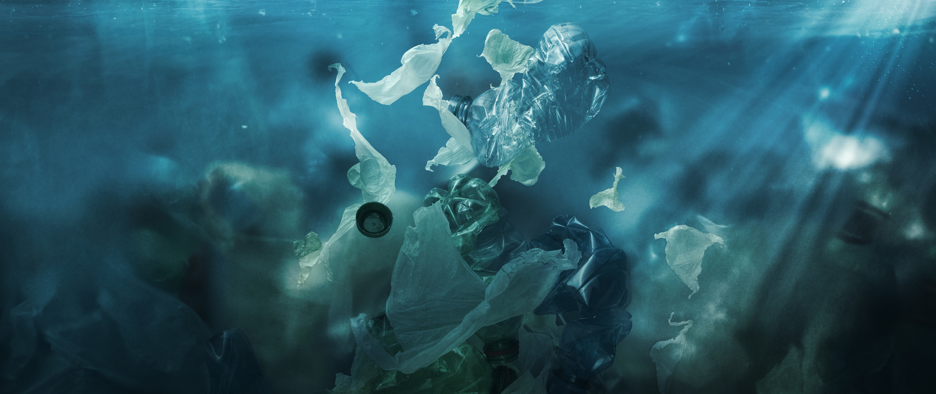 Toxic plastic waste floating underwater in the ocean, water pollution and environmental damage